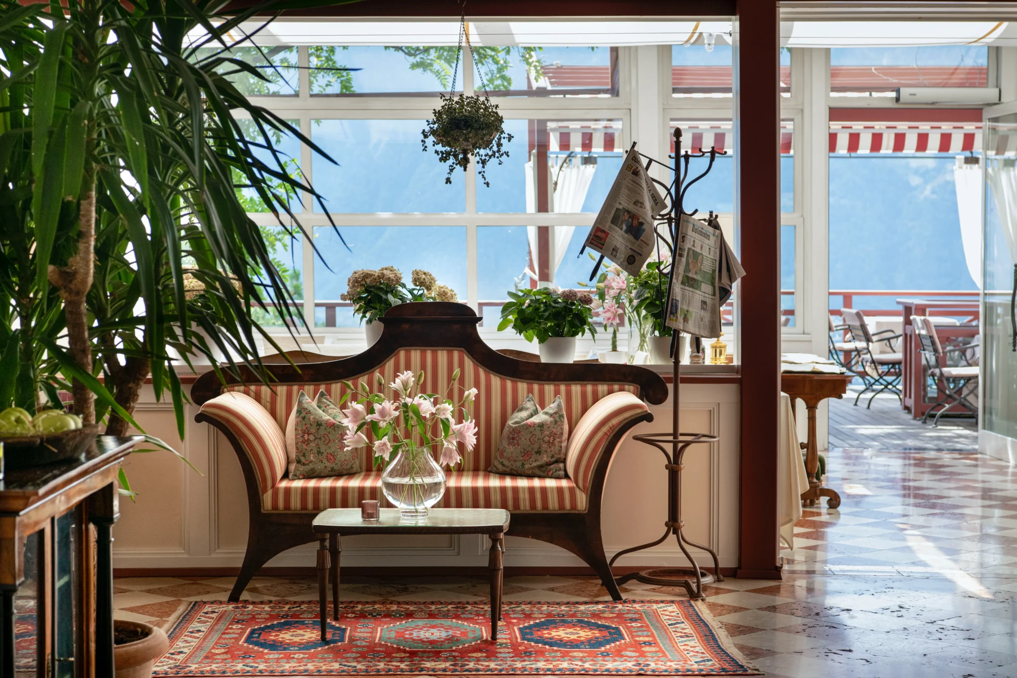 Elegant striped sofa in a hotel lobby overlooking a patio; perfect for an Italian wedding reception.