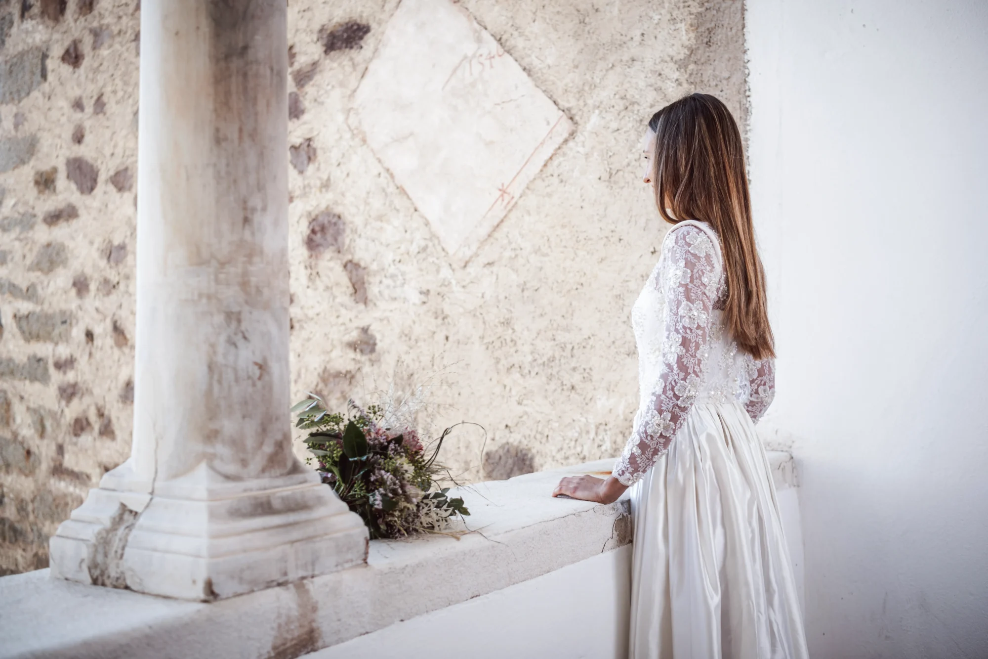 Bride in elegant lace wedding dress at Relais & Châteaux Castel Fragsburg, Italy.