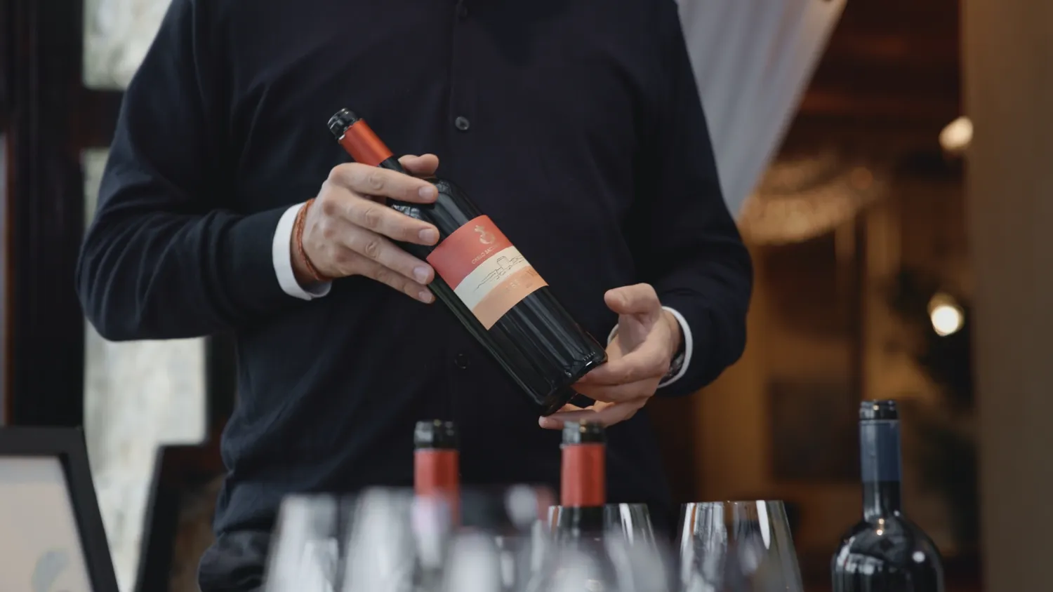 Person holding a bottle of Castello Di Vicarello wine.