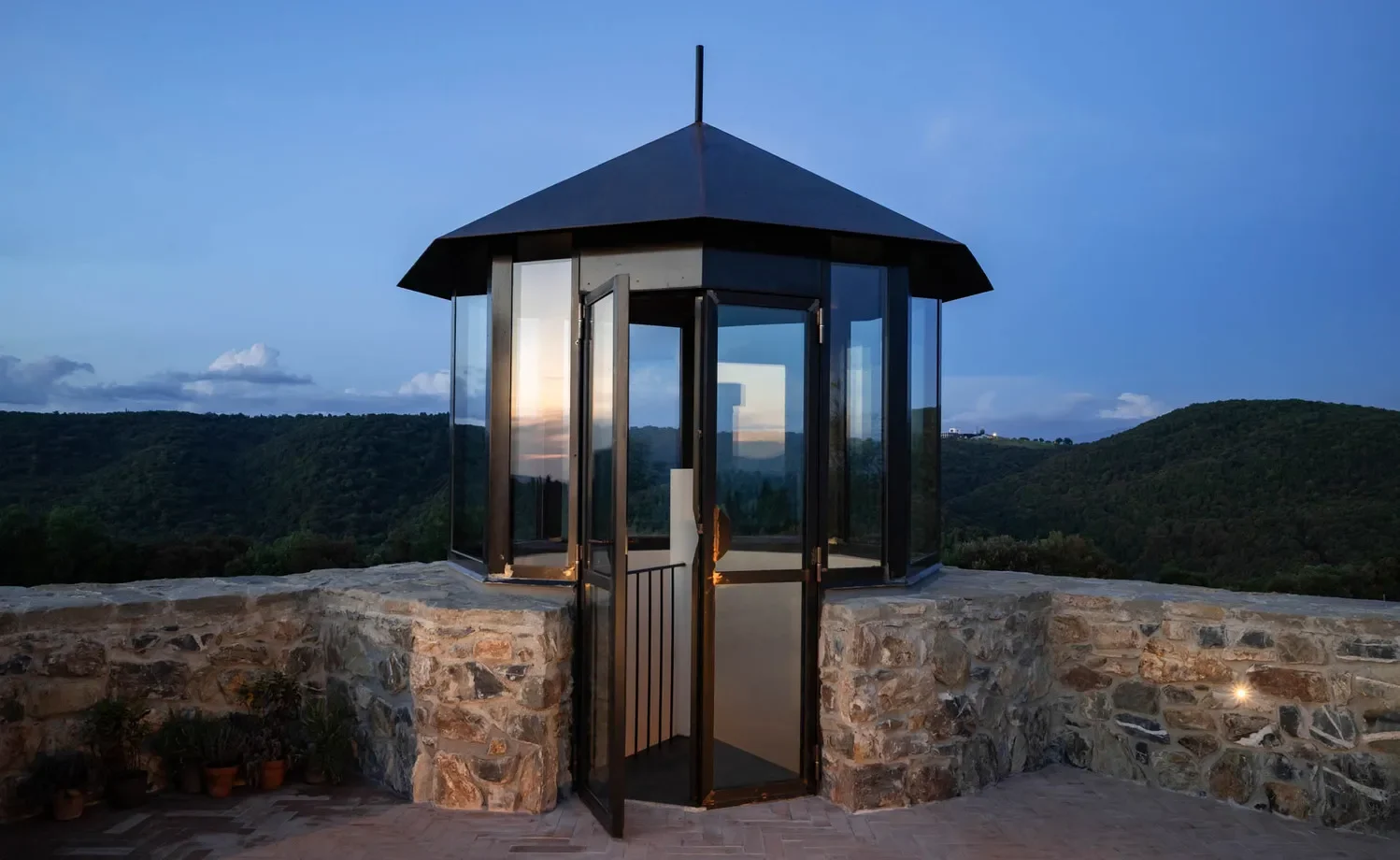 Glass gazebo overlooking Tuscan hills at Castello Di Vicarello, a stunning castle wedding venue.