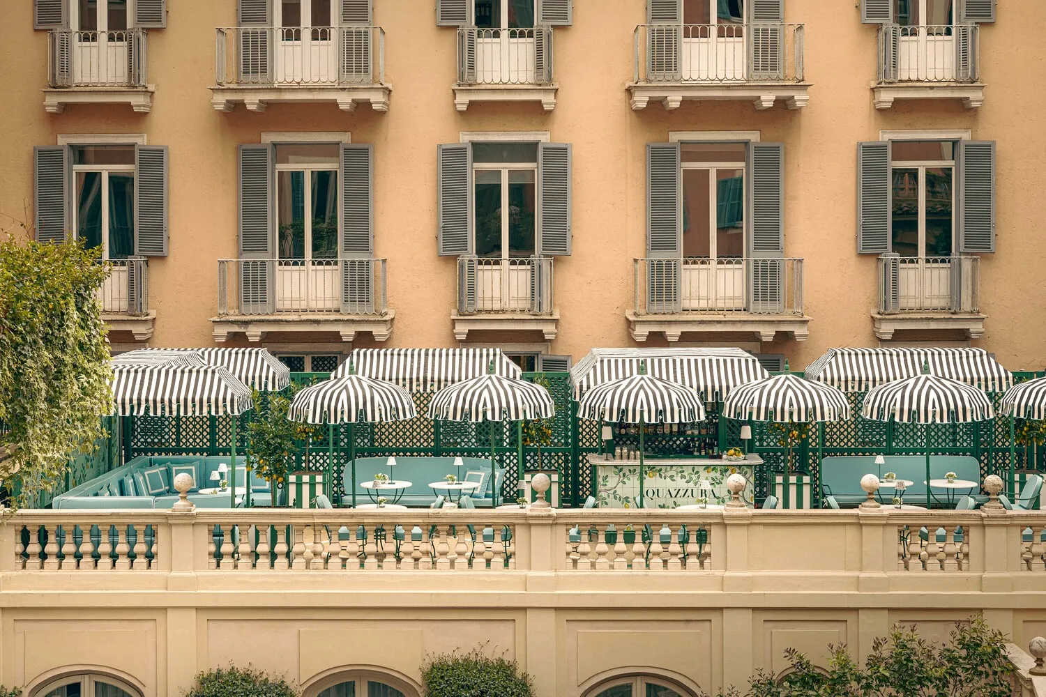 Hotel de Russie's rooftop terrace with striped umbrellas, perfect for a romantic Rome wedding.