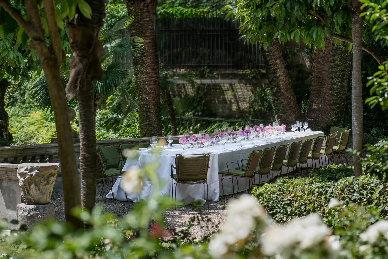 Elegant outdoor wedding reception at Hotel de Russie in Rome. Long table with floral centerpiece.