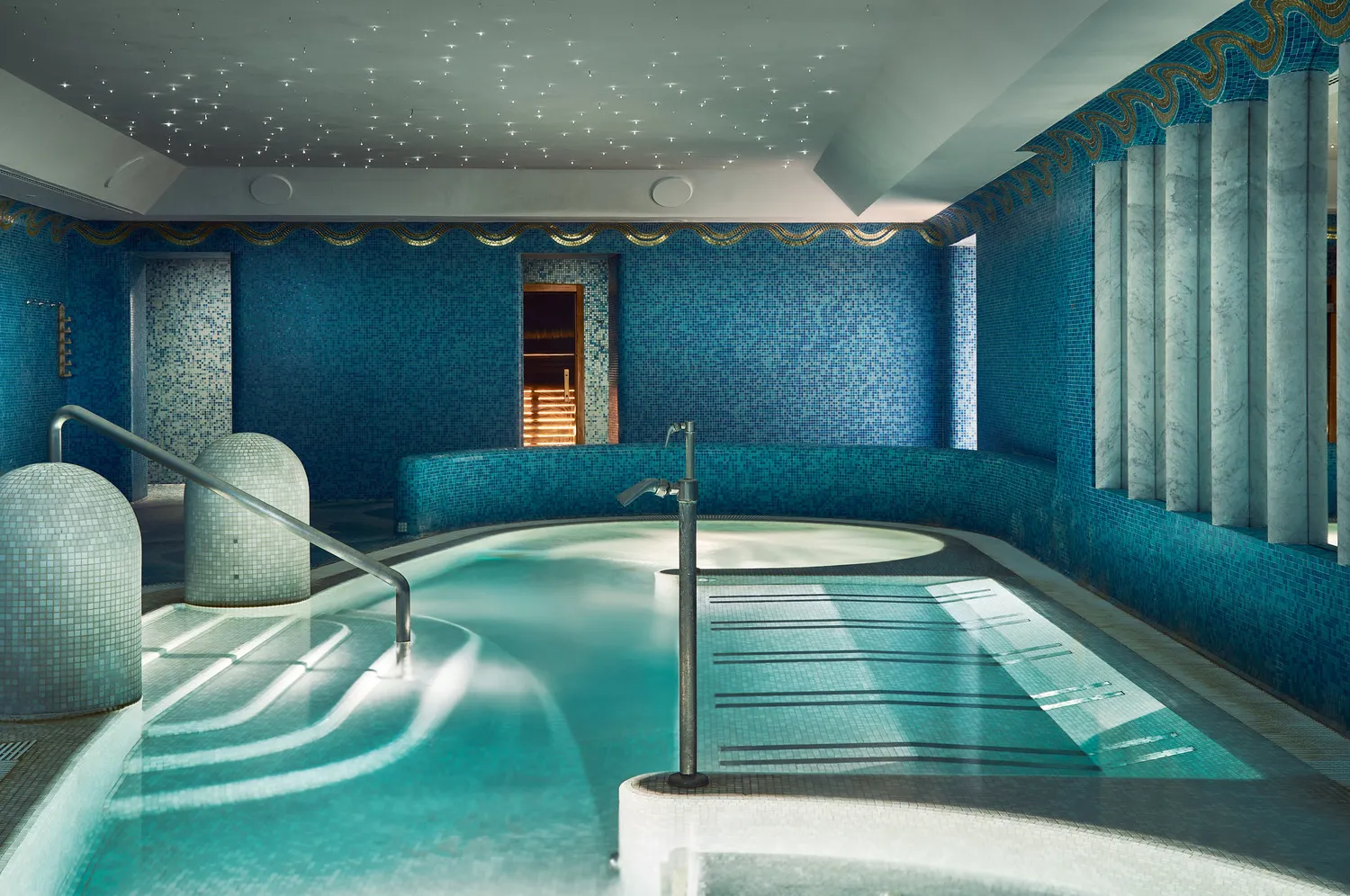 Indoor spa pool at Hotel De Russie, Rome. Relaxing teal tiles and a sauna are visible.