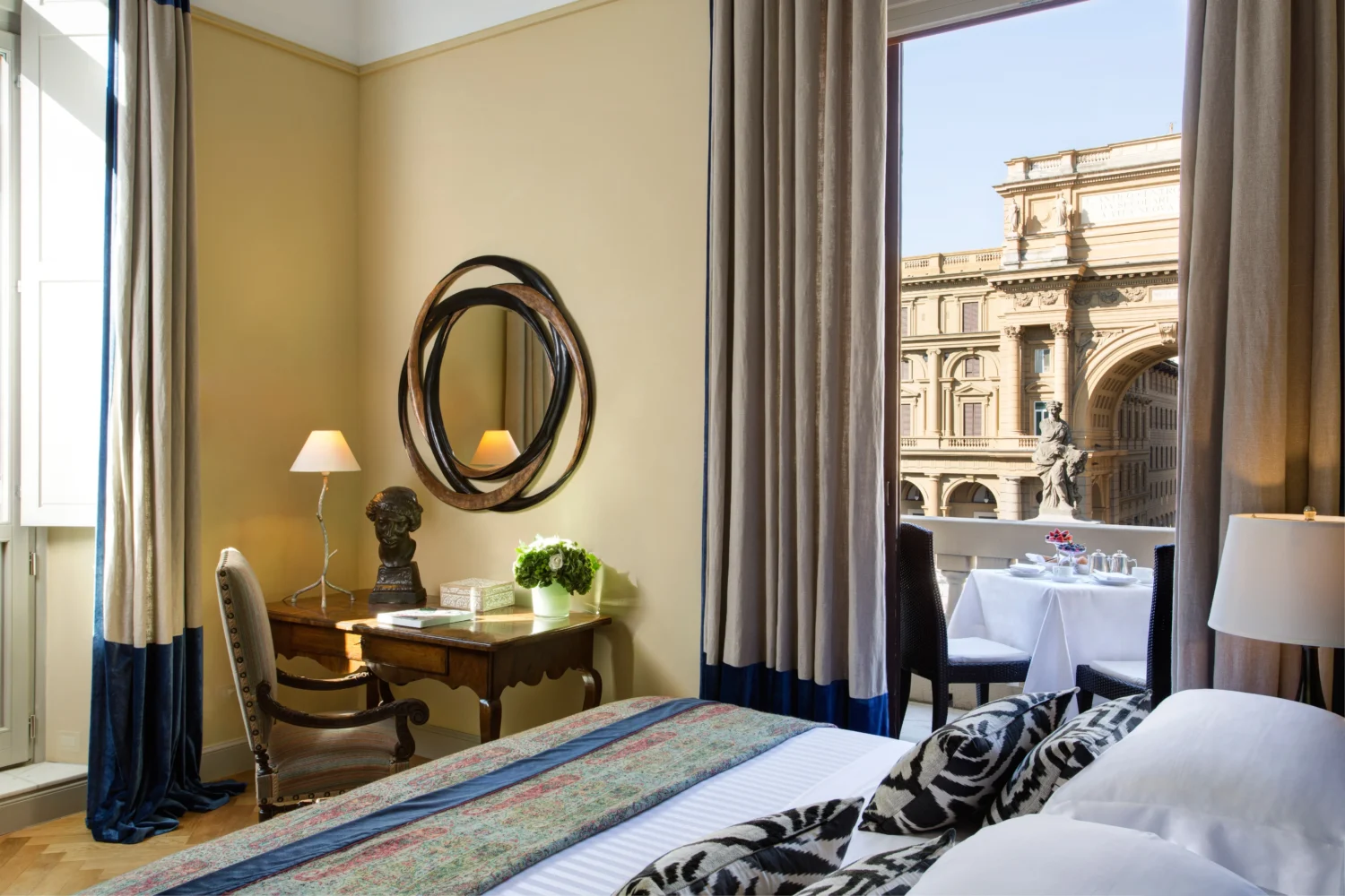 Luxurious Florence hotel room with balcony view of Piazza della Repubblica. Honeymoon suite at Hotel Savoy, a Rocco Forte Hotel.
