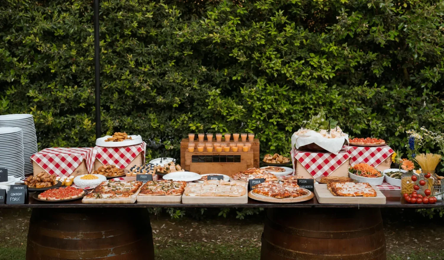 Abundant Italian buffet table at a Relais La Corte Dei Papi wedding in the countryside, featuring various pizzas and appetizers.