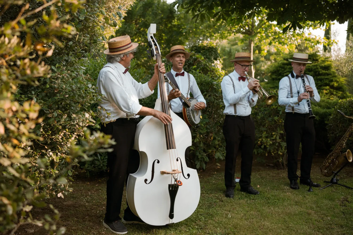 Jazz band in straw hats plays at an Italian countryside wedding.