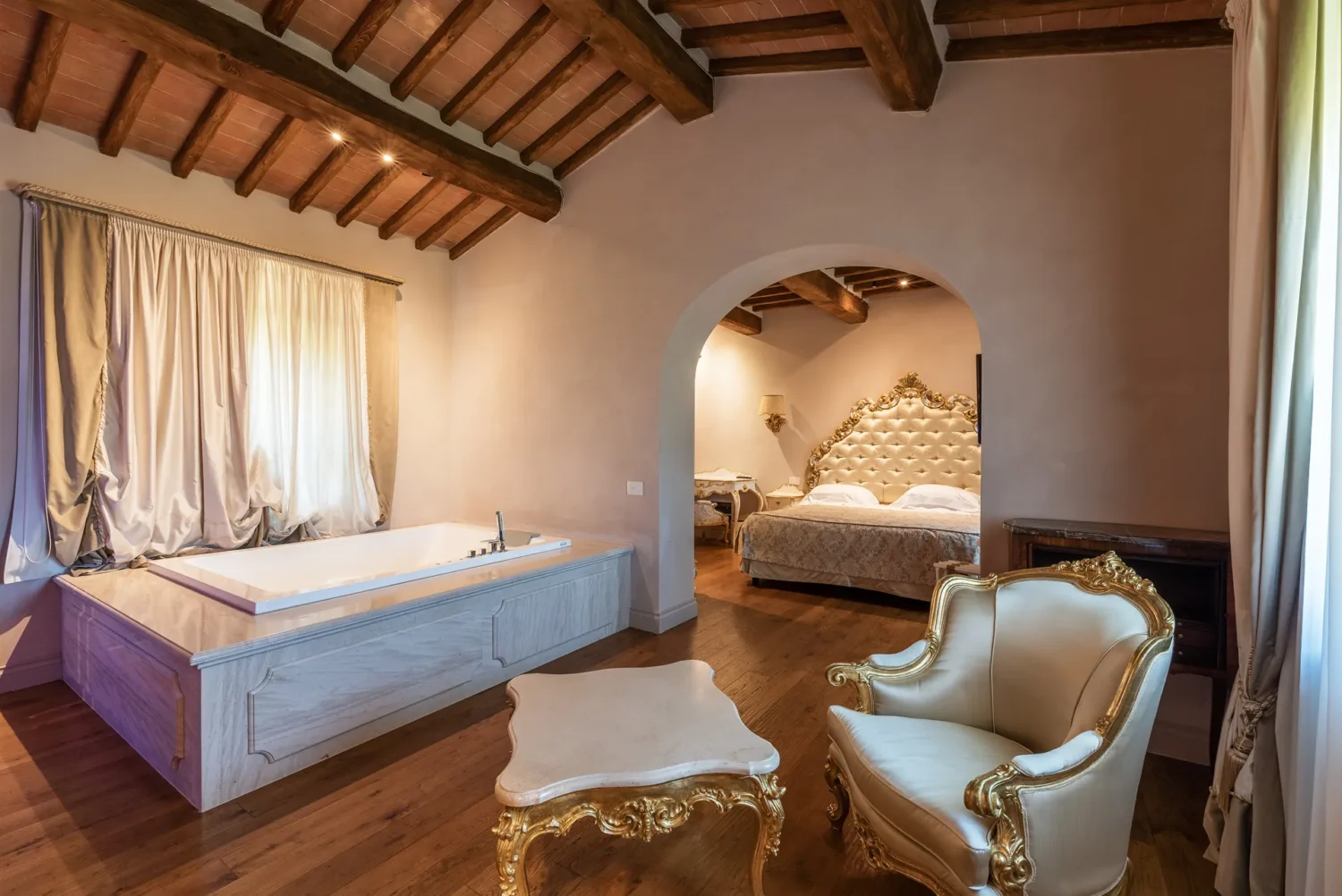 Luxurious Italian countryside bedroom suite with jacuzzi tub and ornate furniture. Perfect for a Relais La Corte Dei Papi wedding.