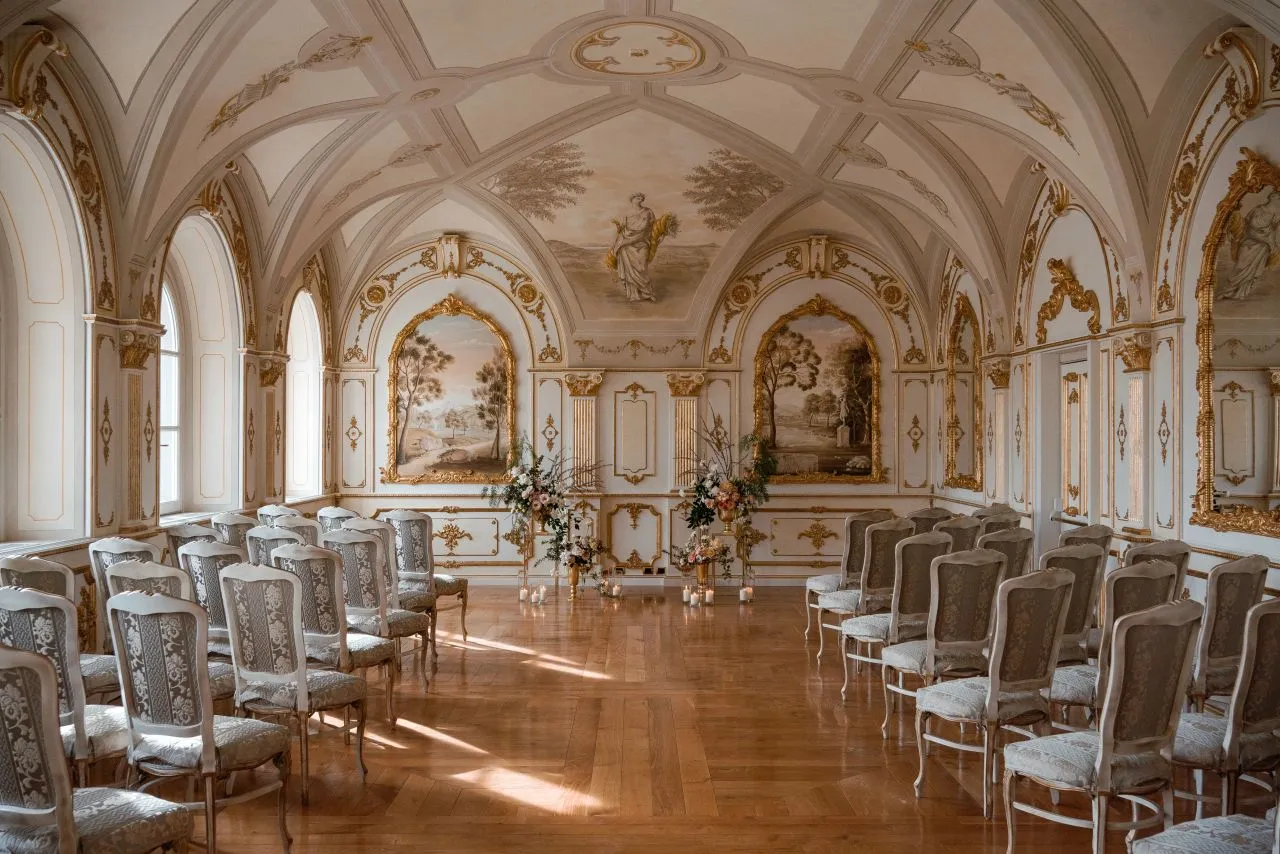 Elegant wedding ceremony setup in a historic Italian villa. Rows of chairs face a floral altar.