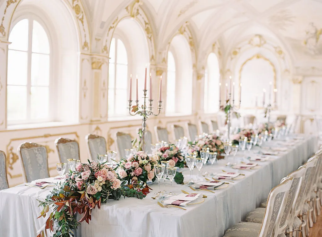 Elegant long wedding table with floral centerpiece in an Italian countryside villa.