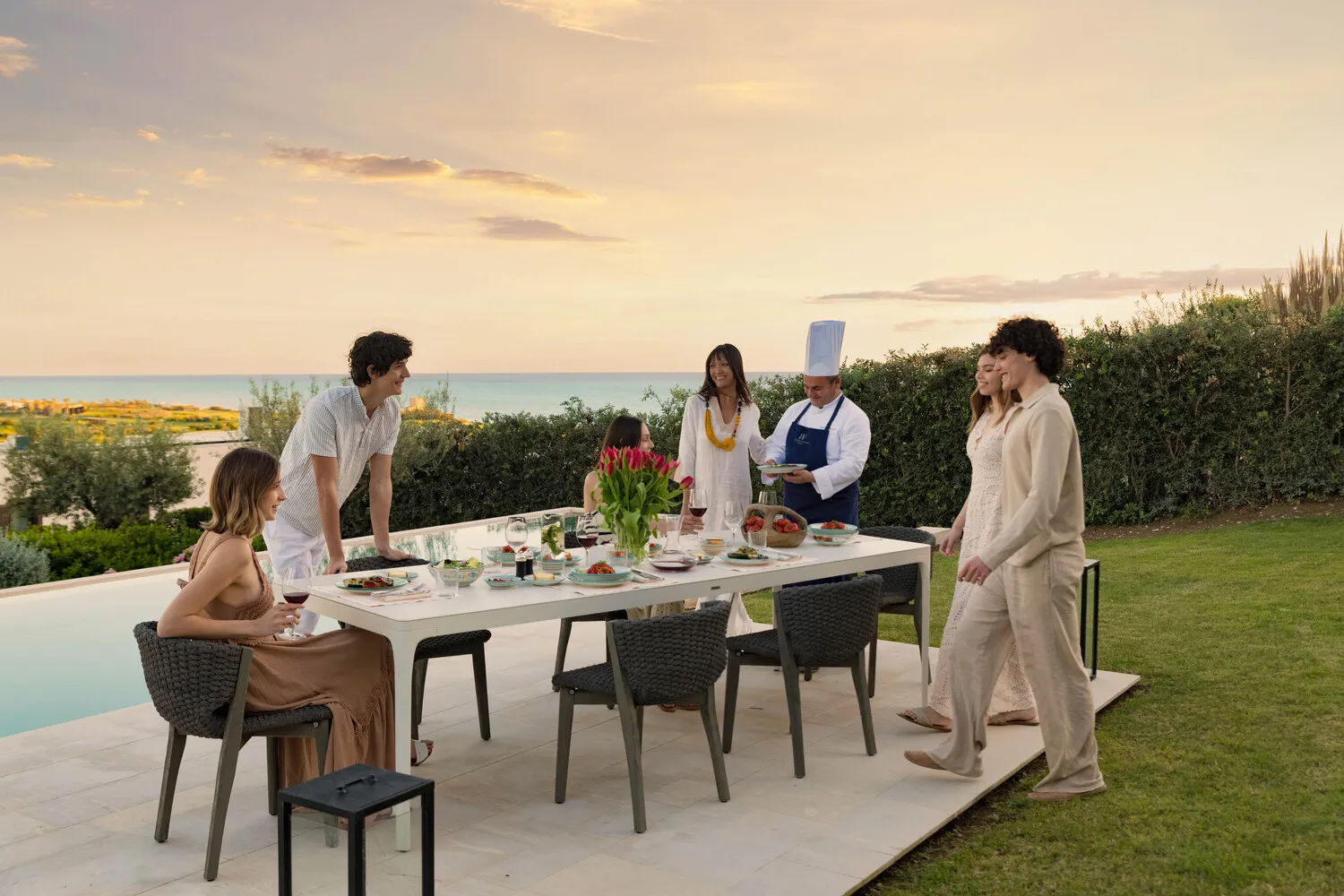Family enjoying sunset dinner at Verdura Resort, Sicily. Destination wedding location.