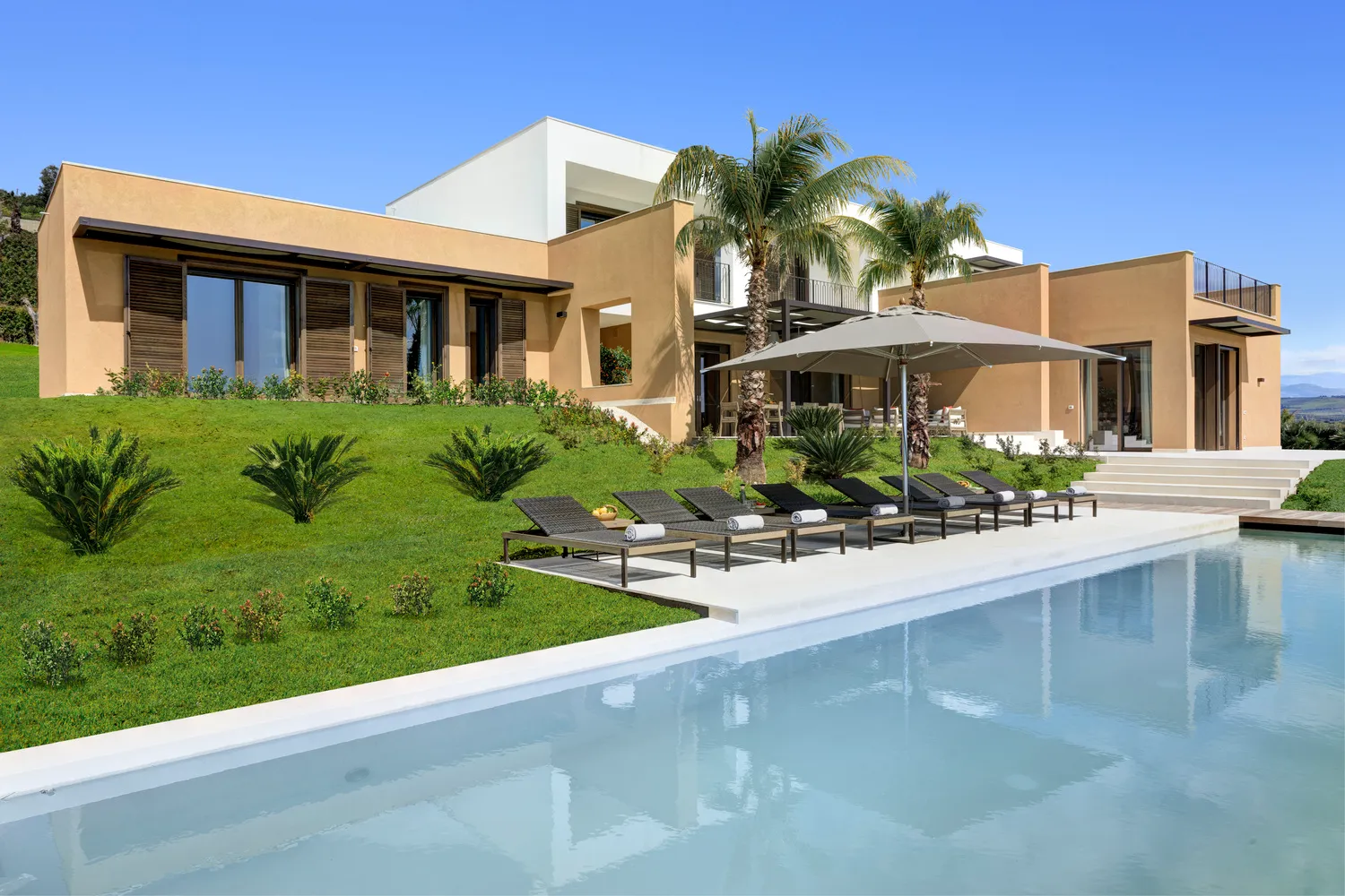 Luxury villa with pool and palm trees at Verdura Resort, Sicily. Ideal Sicily destination wedding location.