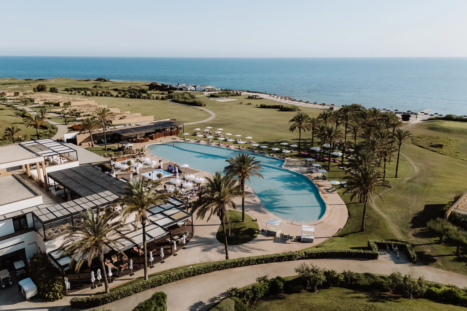 Aerial view of Verdura Resort in Sicily, featuring a stunning pool and lush landscaping. Perfect for a destination wedding.