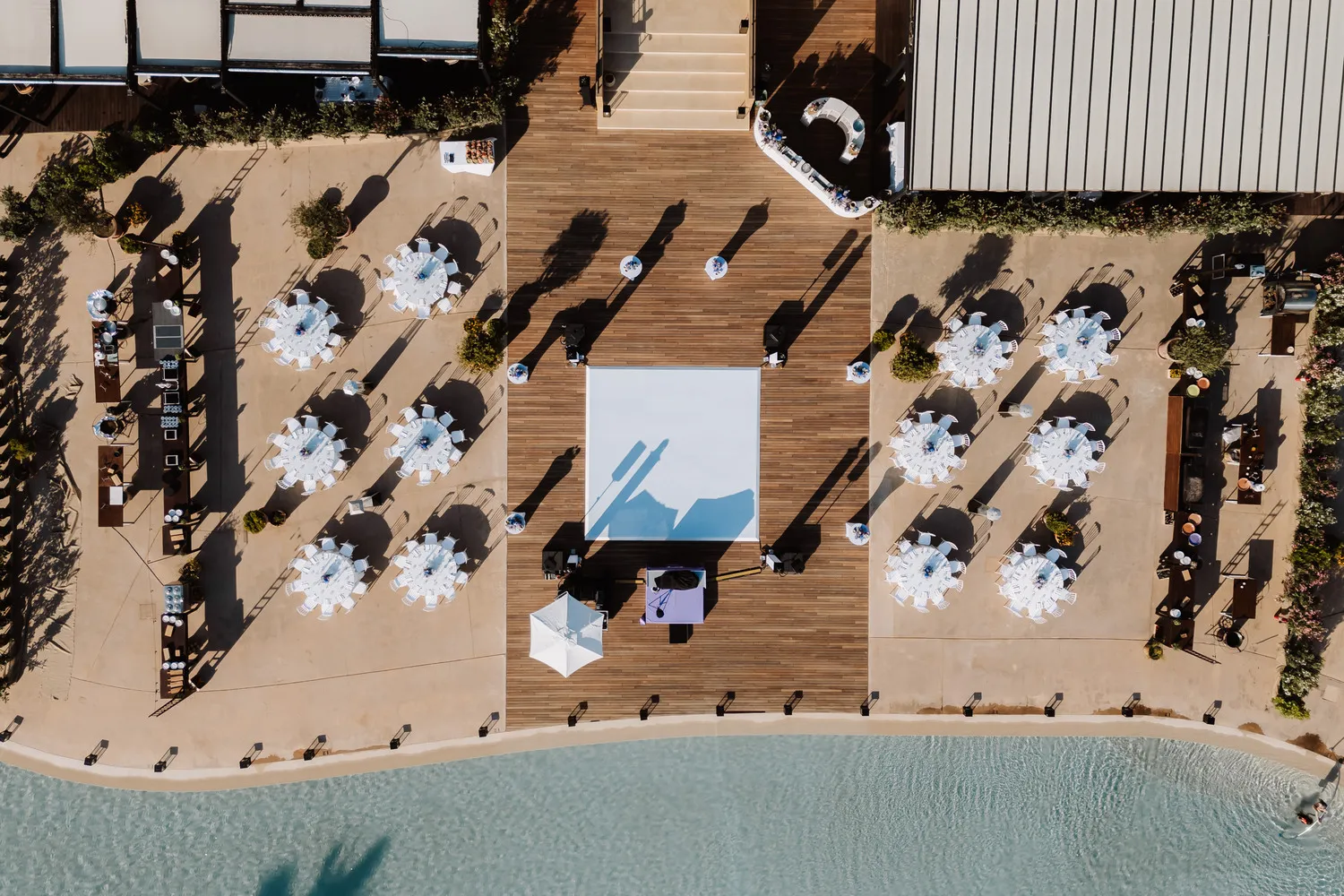Aerial view of a luxurious Sicily destination wedding at Verdura Resort, featuring a dance floor and reception tables.