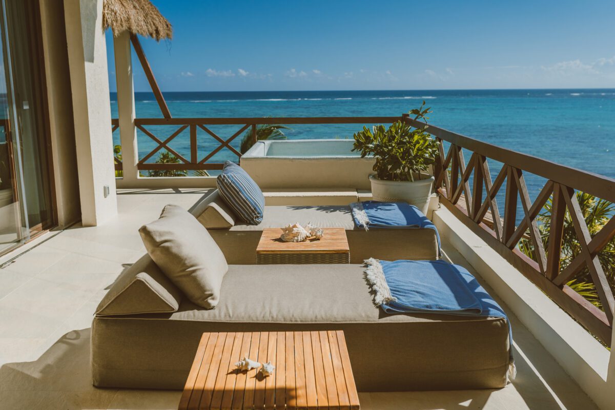 Luxury lounge chairs on a balcony overlooking the ocean at Jashita Hotel Tulum, a Tulum wedding venue.