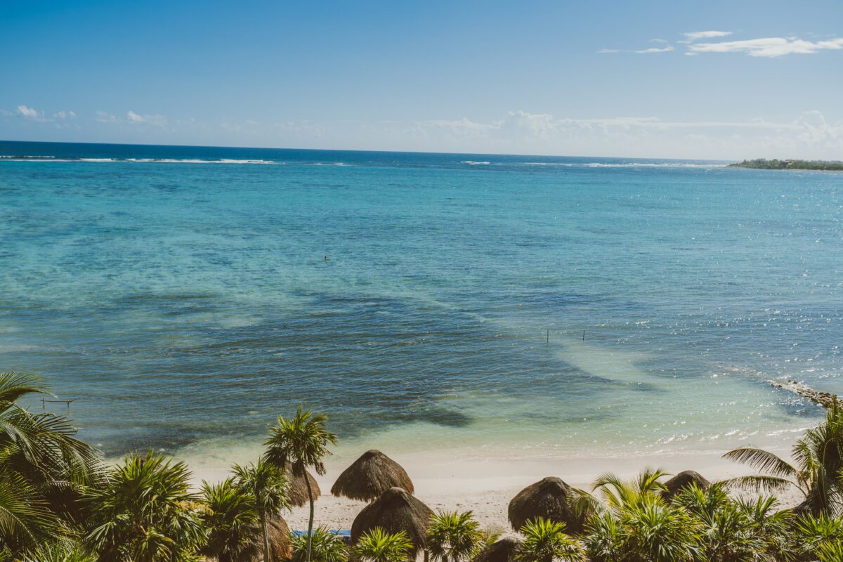 Beach view from Jashita Hotel Tulum, a beautiful Tulum wedding venue with turquoise water and palm trees.