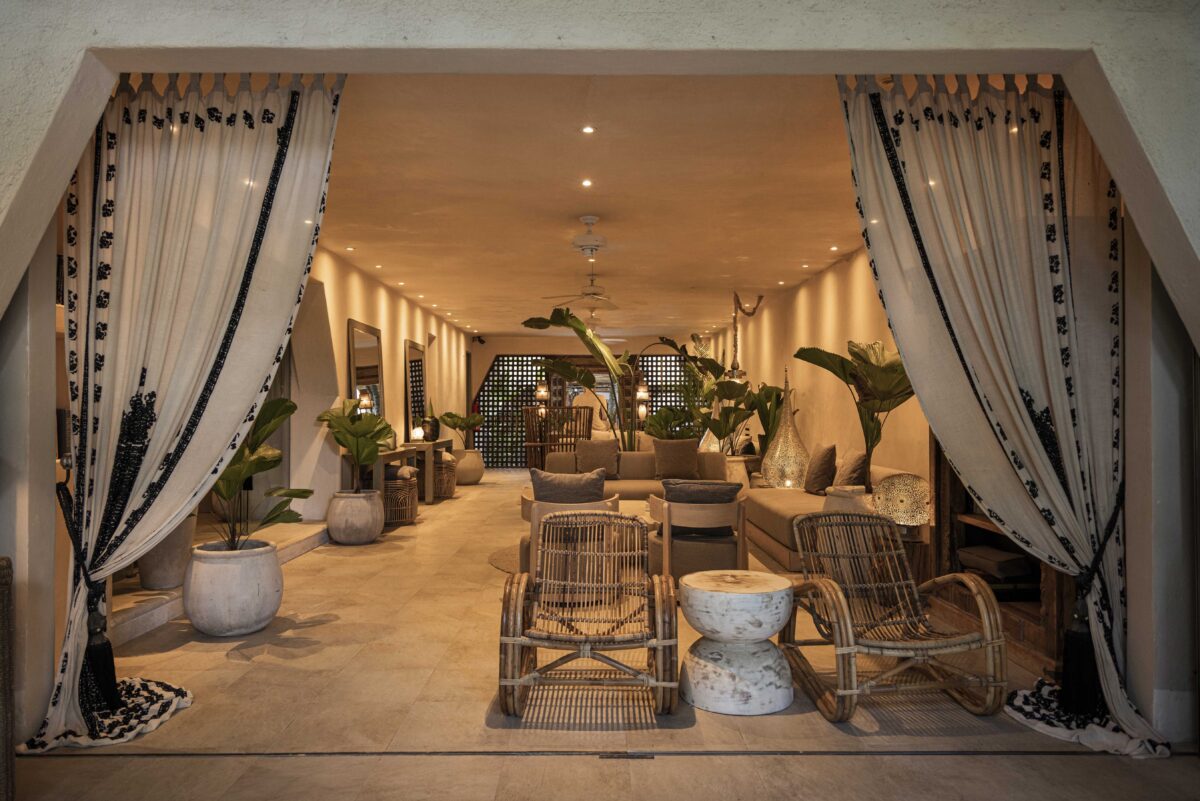 Jashita Hotel Tulum lobby with rattan chairs and tropical plants. A potential Tulum wedding venue.