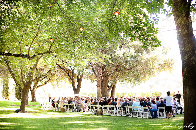 Tropical resort pool at sunset with palm trees and lanterns