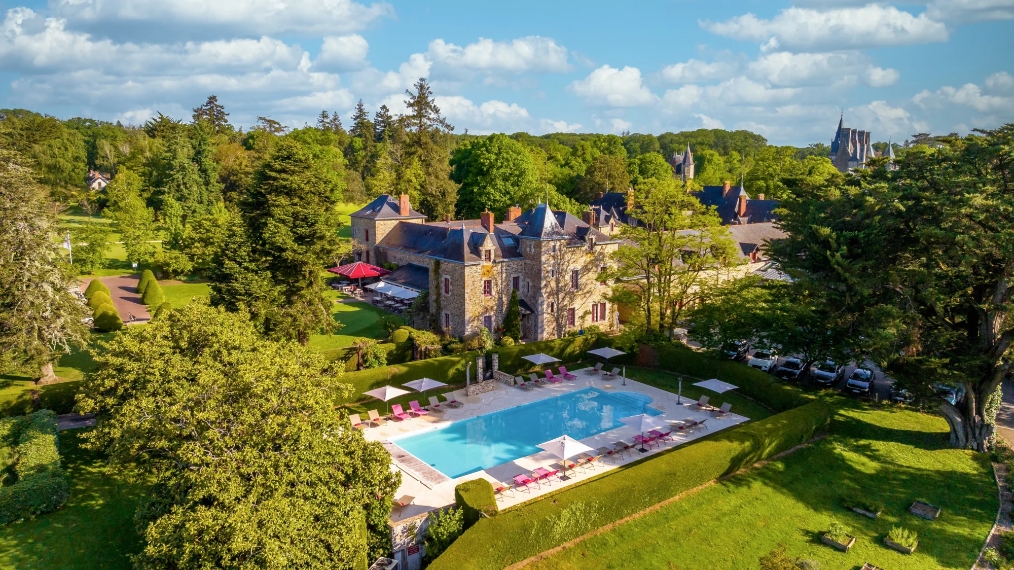 Aerial view of Domaine de la Bretesche, a French castle with a pool, ideal for a French castle wedding.