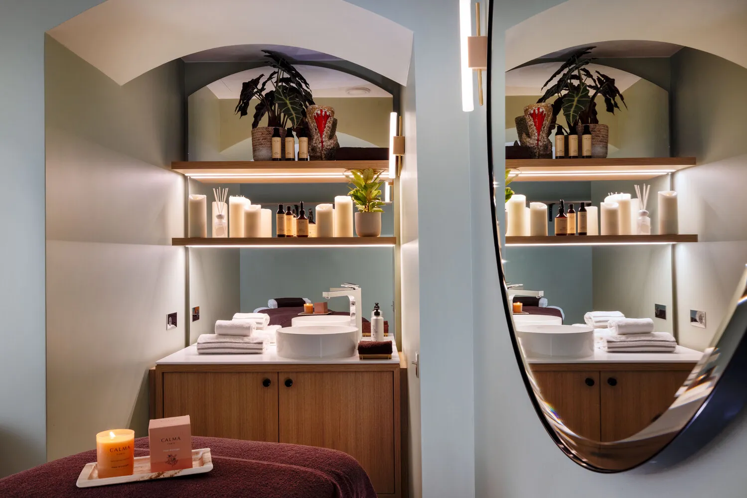 Spa treatment room at Hotel de Sers, featuring a calming design with candles and toiletries.