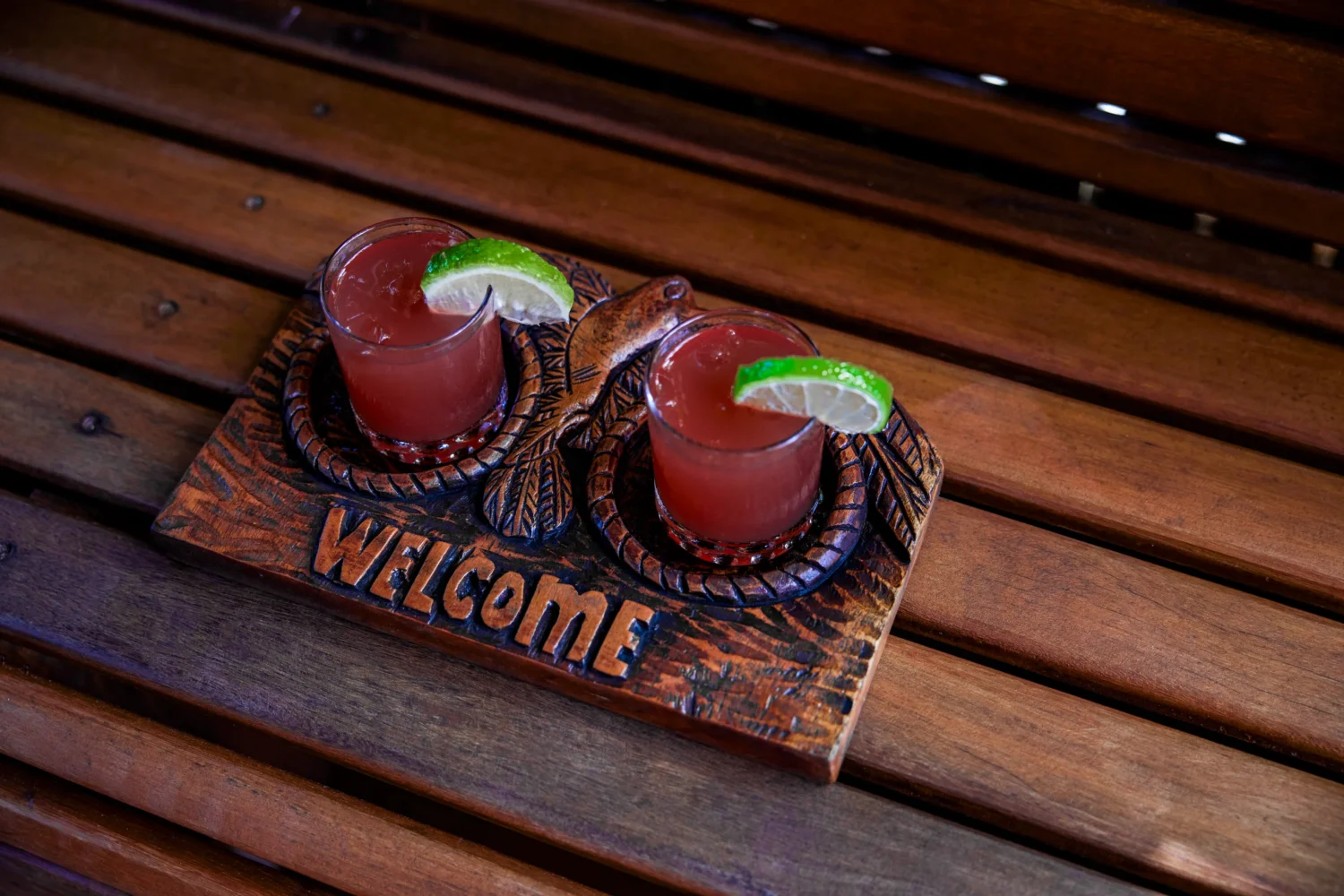 Welcome drinks on a carved wooden tray at Ladera Resort. Perfect for an Island Wedding & Honeymoon.