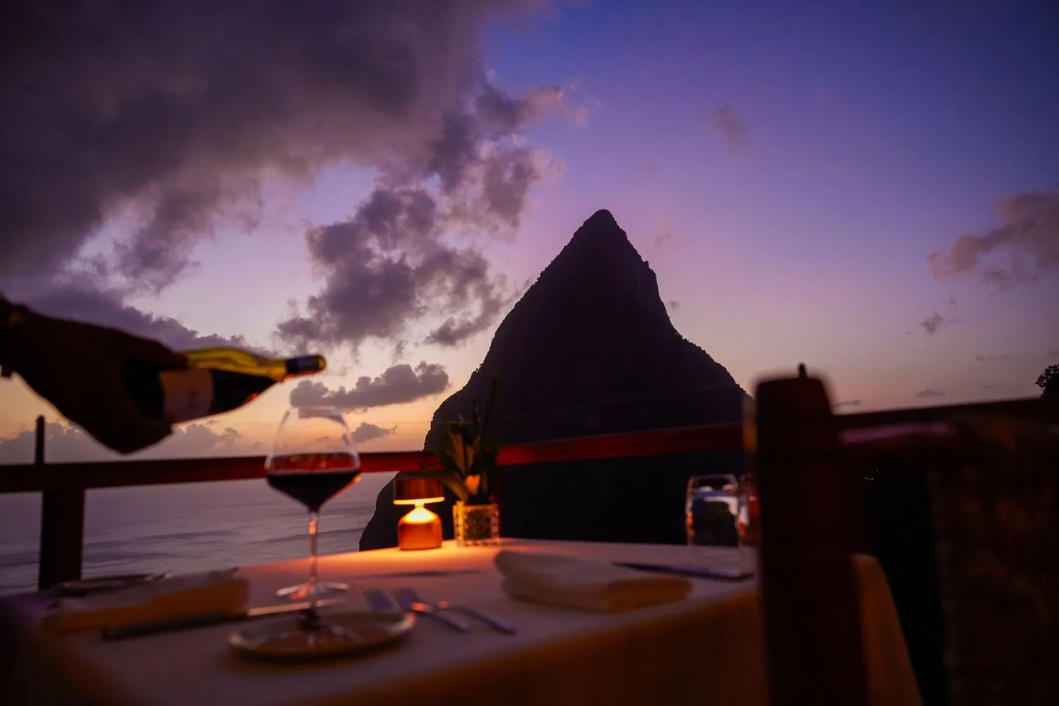Romantic sunset dinner for a St. Lucia honeymoon at Ladera Resort, overlooking the Pitons.