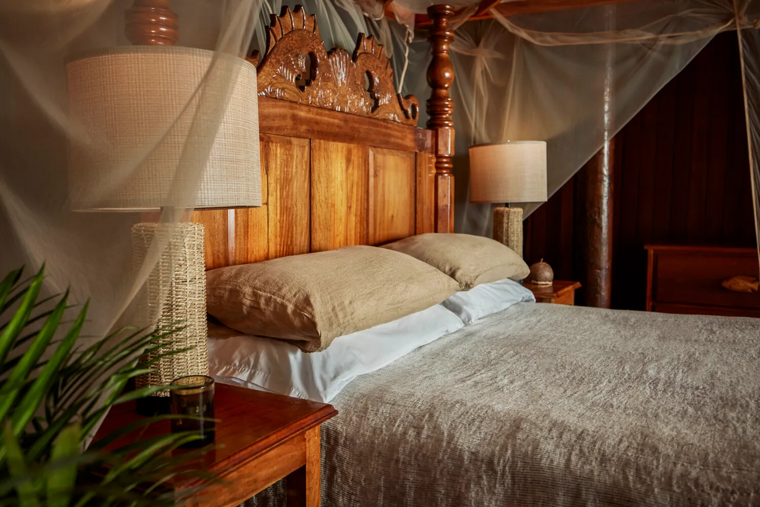 Luxurious four-poster bed in a romantic island bedroom, perfect for a honeymoon or wedding at Ladera Resort.