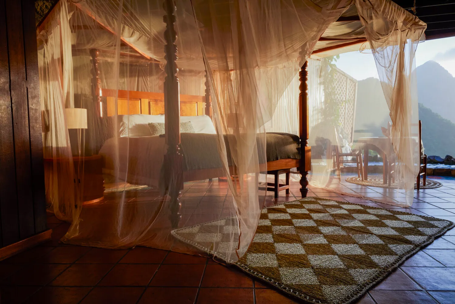 Luxurious four-poster bed with mosquito netting, perfect for an island honeymoon at Ladera Resort.