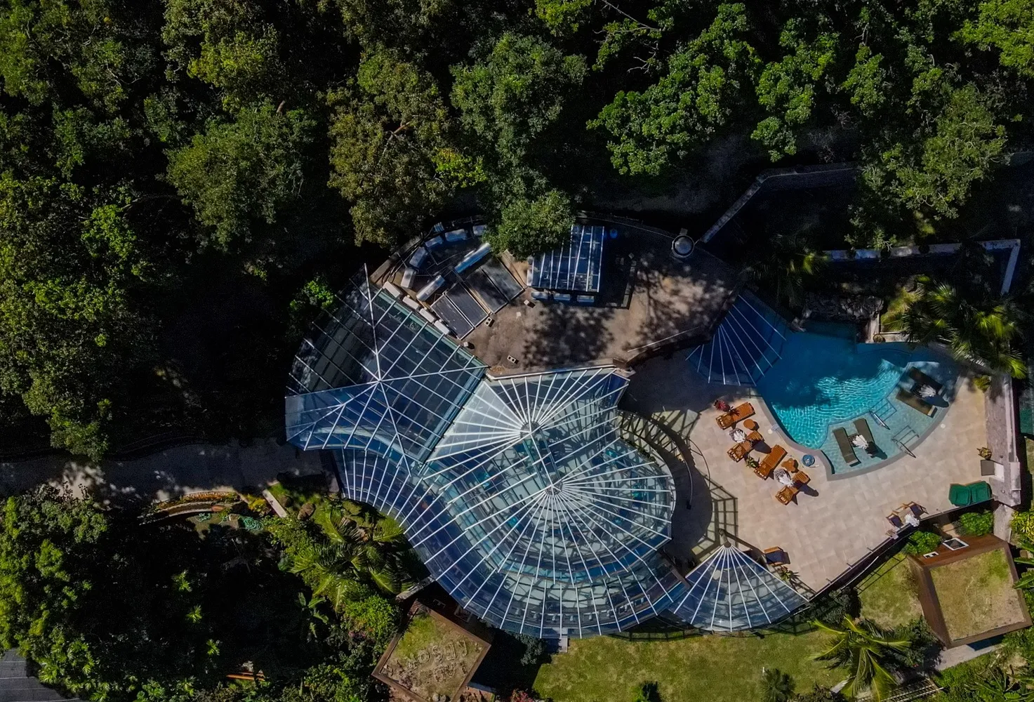 Aerial view of Ladera Resort's stunning pool and glass-roofed structure, perfect for an island wedding or honeymoon.