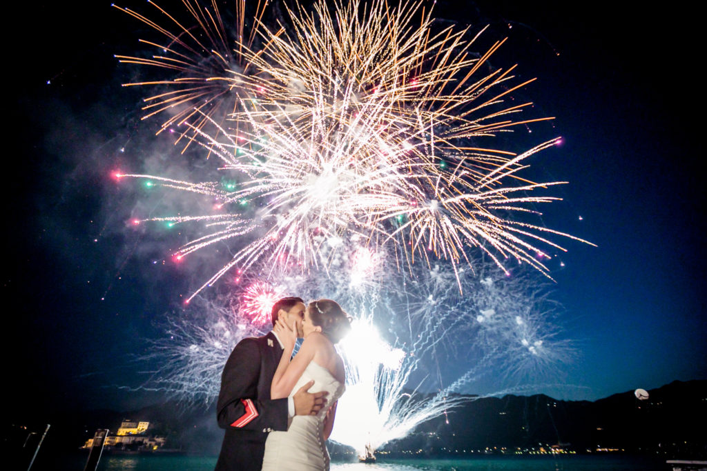 Tropical resort pool at sunset with palm trees and lanterns