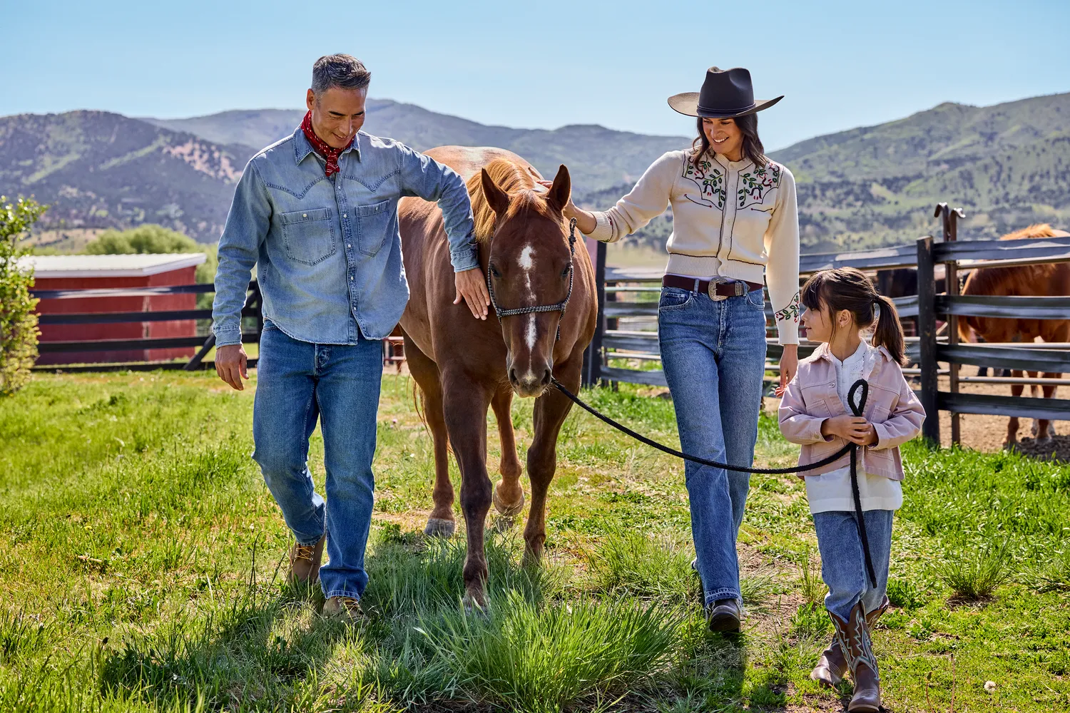 Family walks horse at Utah ranch, reminiscent of a Utah ranch wedding.