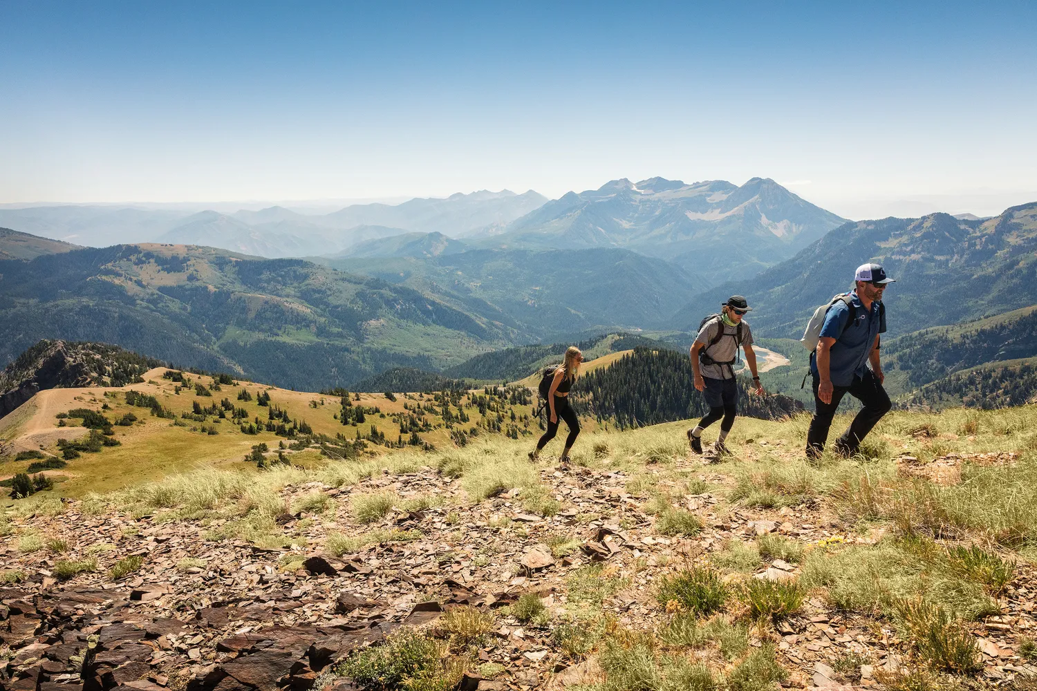 Hikers enjoying a mountaintop view in Utah.