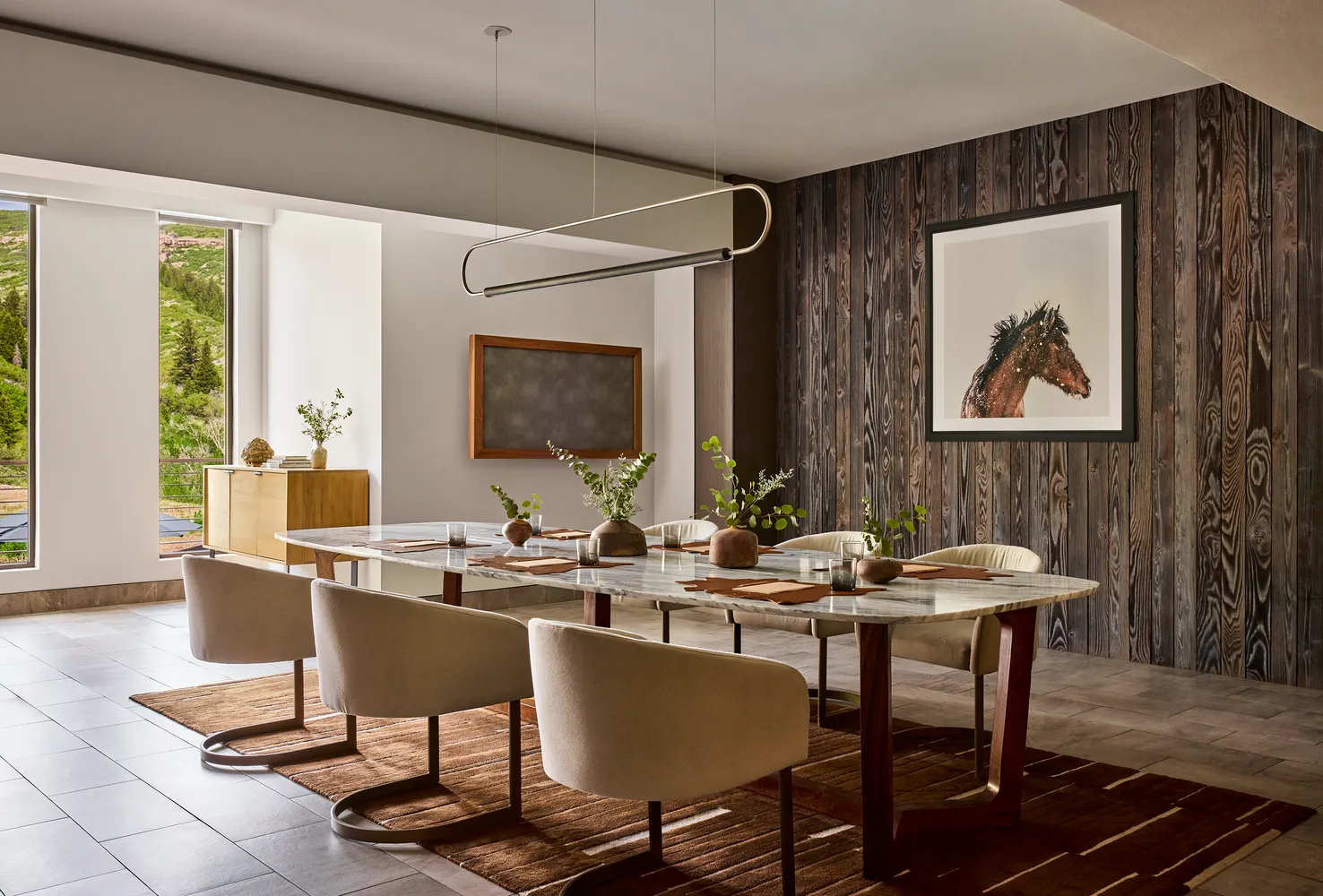 Elegant dining room at The Lodge at Blue Sky, featuring a marble table and rustic wood wall. Perfect for a Utah ranch wedding.