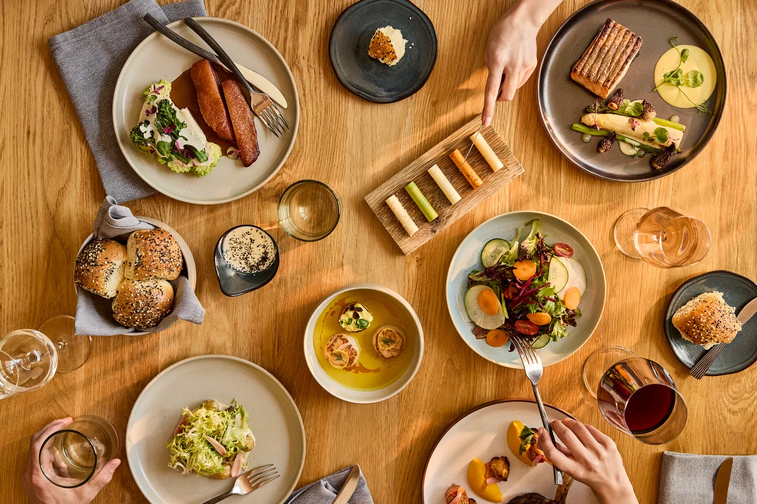 Overhead view of elegant dinner setting with various dishes, perfect for a Utah Ranch Wedding at The Lodge at Blue Sky, Auberge Resorts Collection.