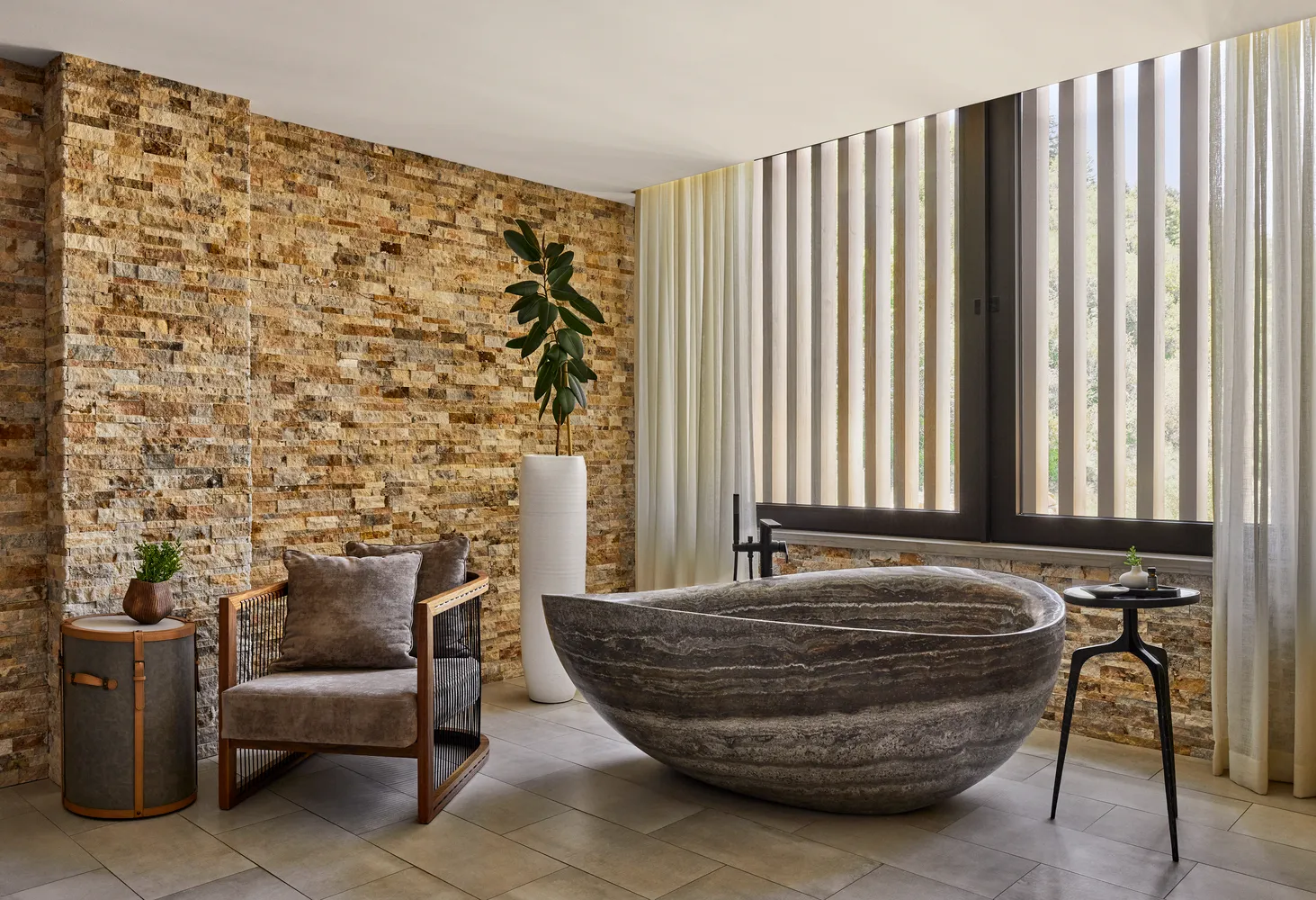 Luxurious bathroom at The Lodge at Blue Sky, featuring a stone bathtub and comfortable seating.