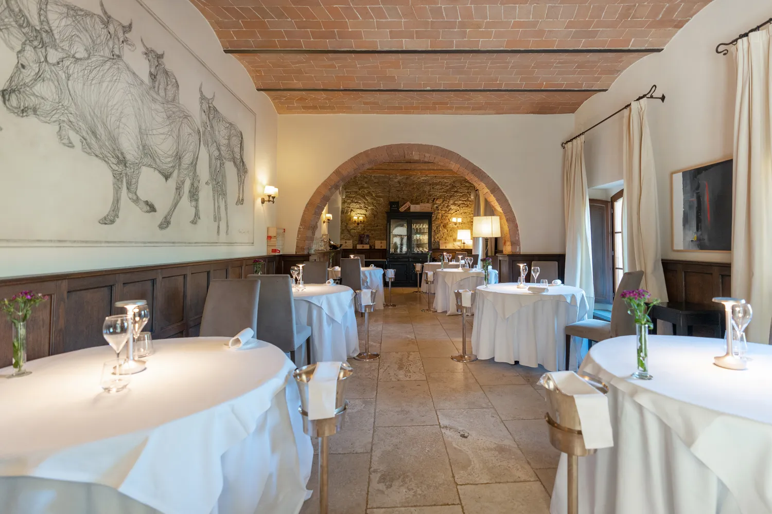 Elegant dining room at Castel Monastero in Tuscany, perfect for weddings and honeymoons.