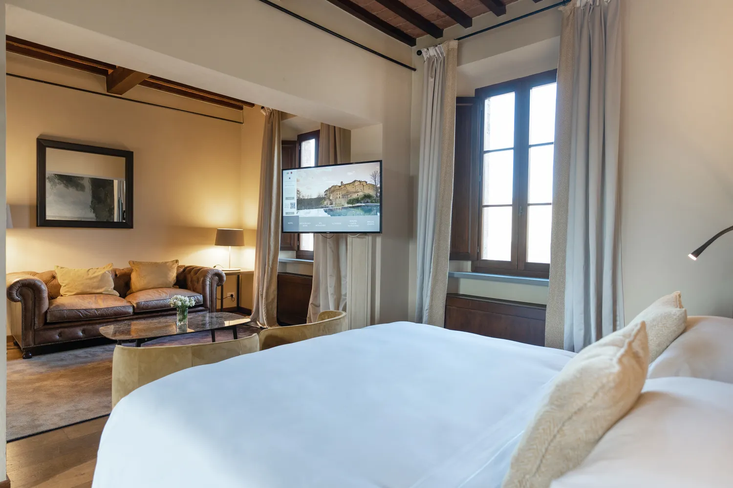 Luxurious Tuscany bedroom suite with sitting area, perfect for a romantic honeymoon or wedding.