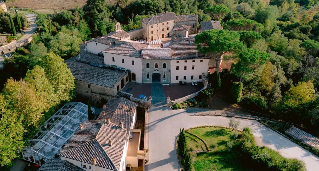 Aerial view of Castel Monastero in Tuscany, ideal for weddings and honeymoons.