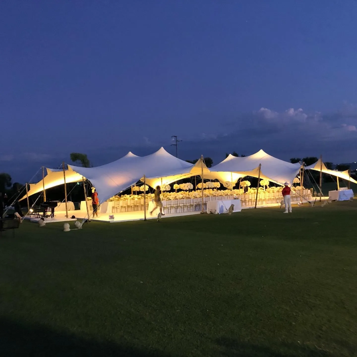 Elegant Puglia wedding reception under a sailcloth tent at Masseria Torre Maizza.