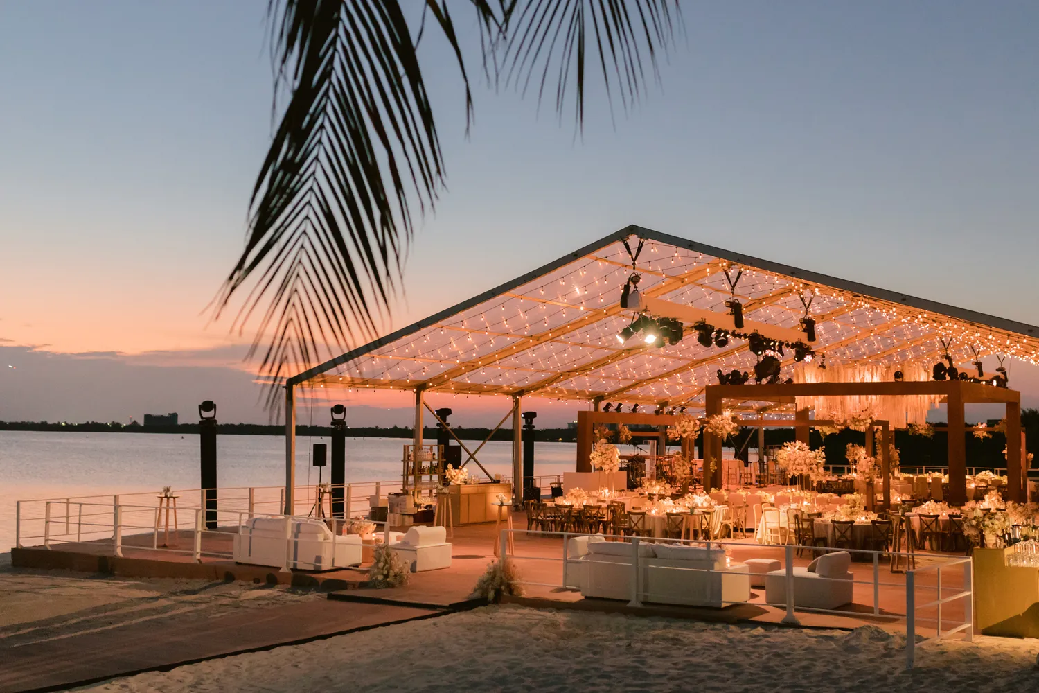 Elegant Cancun wedding reception at NIZUC Resort & Spa, overlooking the ocean at sunset.