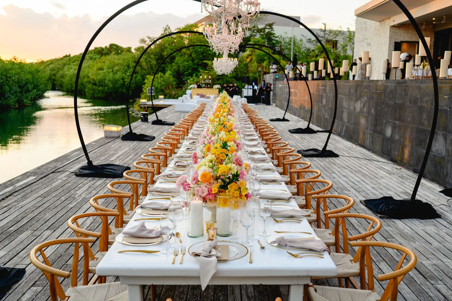 Elegant Cancun wedding reception at NIZUC Resort & Spa, featuring a long table with floral centerpieces.