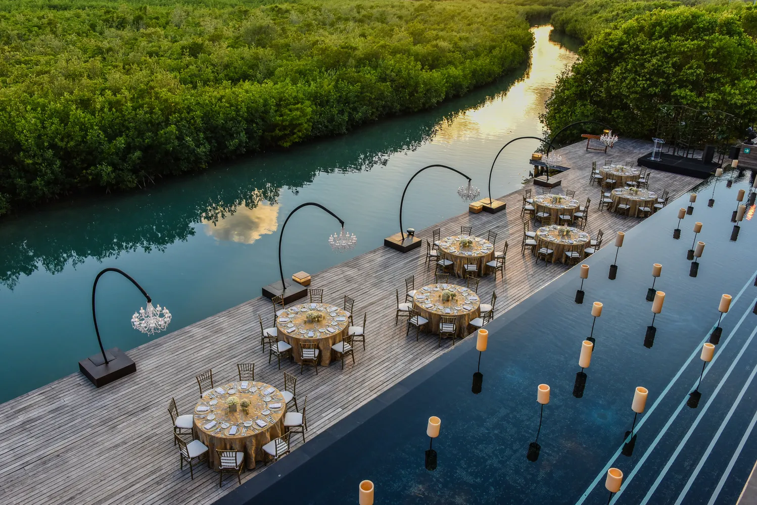 Elegant Cancun wedding reception at NIZUC Resort & Spa, overlooking a tranquil lagoon.