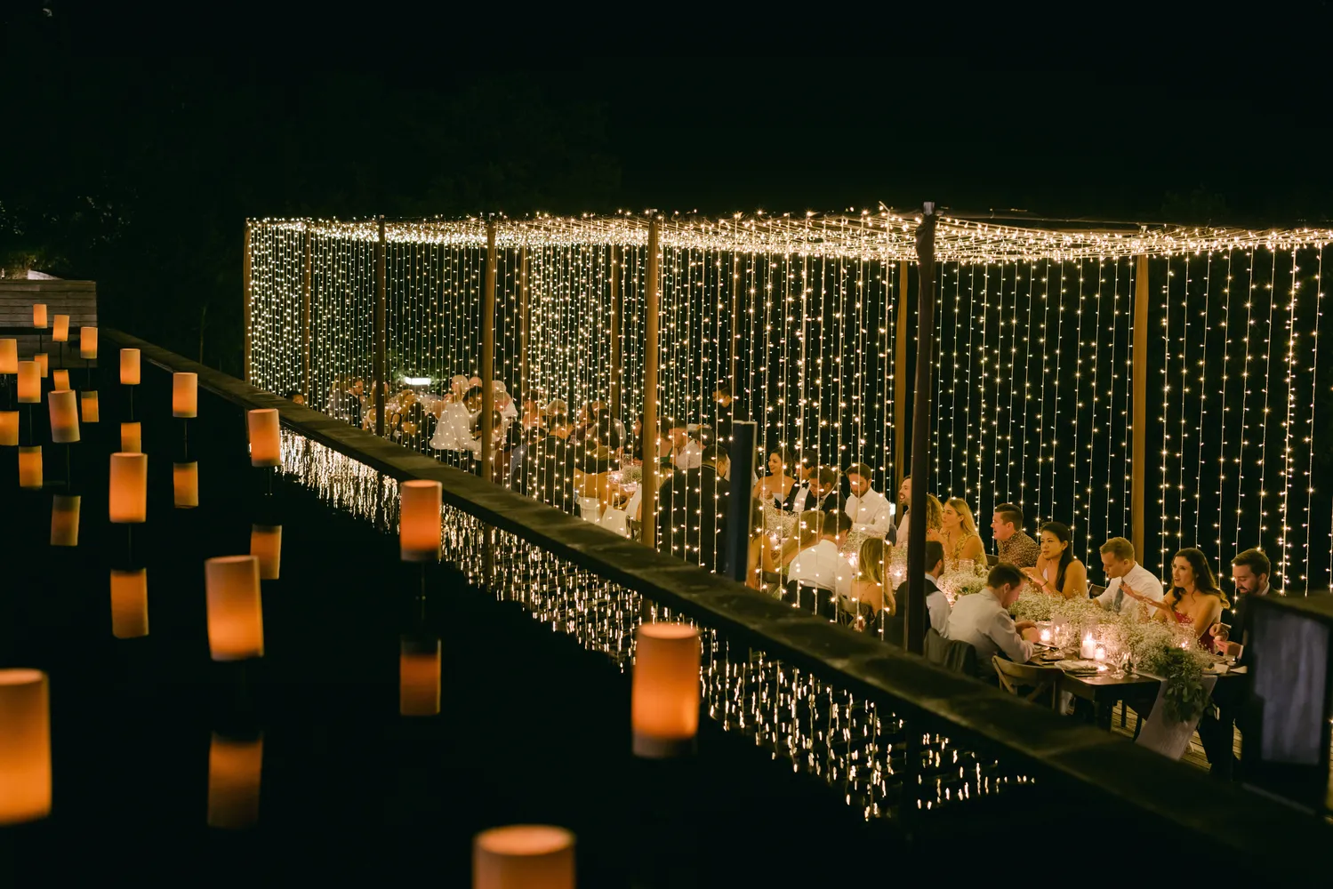 Romantic Cancun wedding reception at NIZUC Resort & Spa, guests seated under twinkling lights.