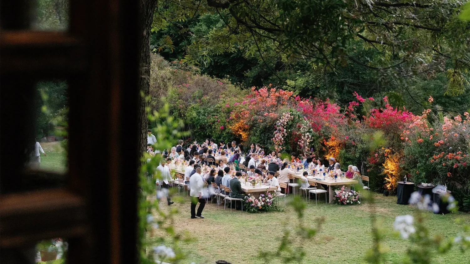 Outdoor wedding reception at Casa de Sierra Nevada, Belmond Hotel, San Miguel de Allende. Guests seated at long tables.