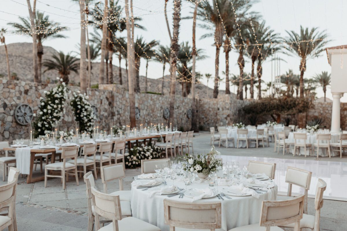 Los Cabos destination wedding reception with round tables and string lights.