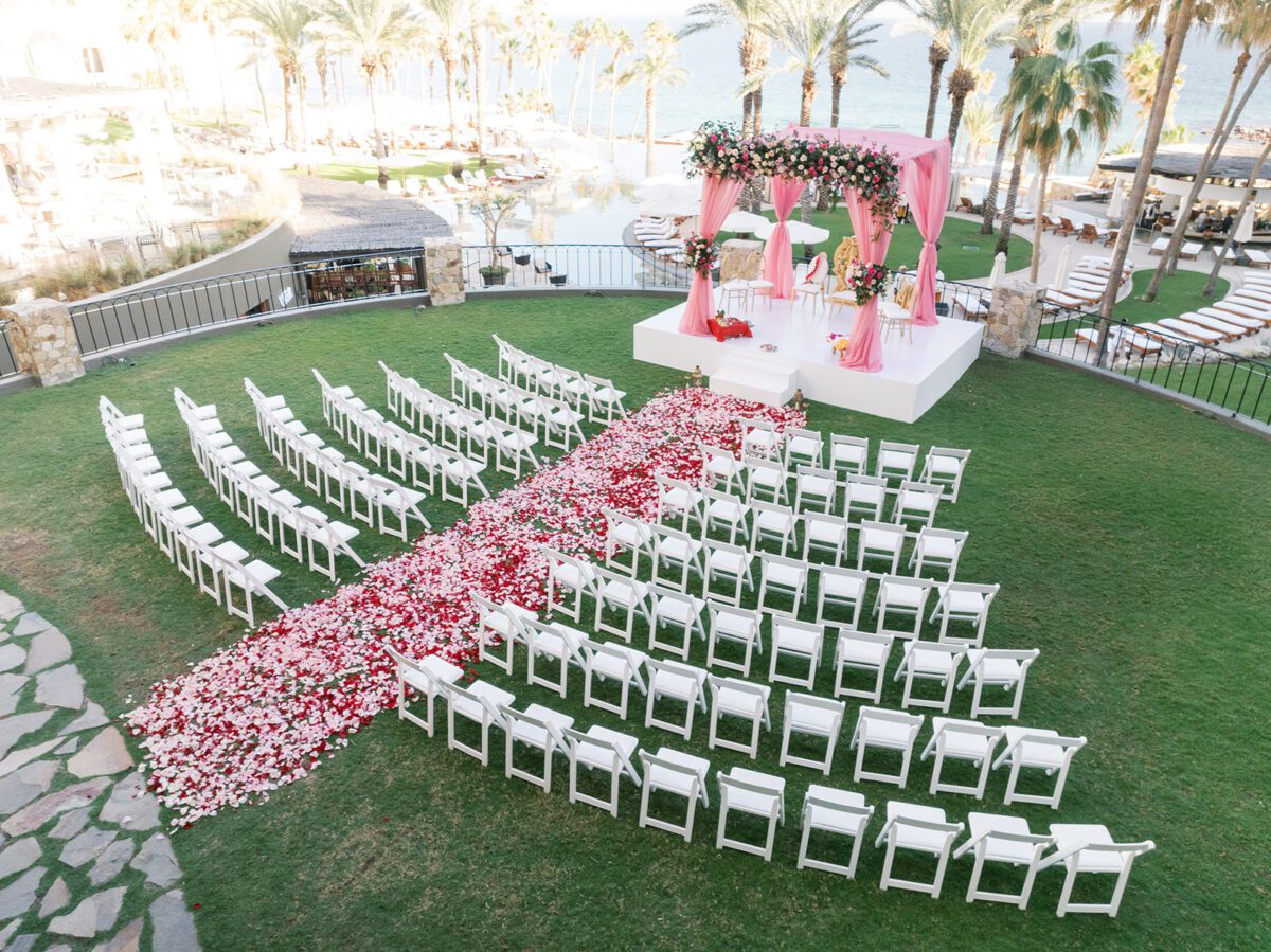 Los Cabos destination wedding setup at Hilton Los Cabos with pink mandap and rose petal aisle.