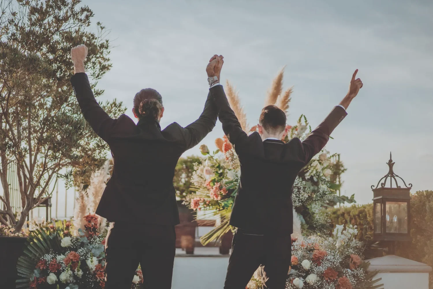 Happy gay couple celebrating at their Casa de Sierra Nevada wedding in San Miguel de Allende.