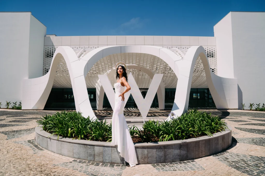 Bride in white gown poses at W Algarve, Portugal. Destination wedding.