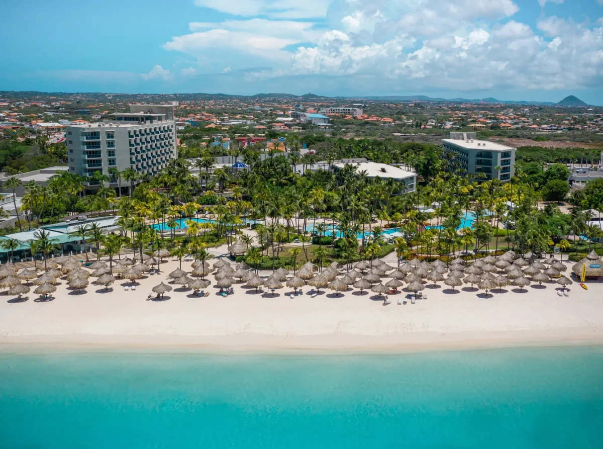 Aerial view of Hilton Aruba Caribbean Resort with a beautiful beach and turquoise water, perfect for a Hilton Aruba Destination Wedding.