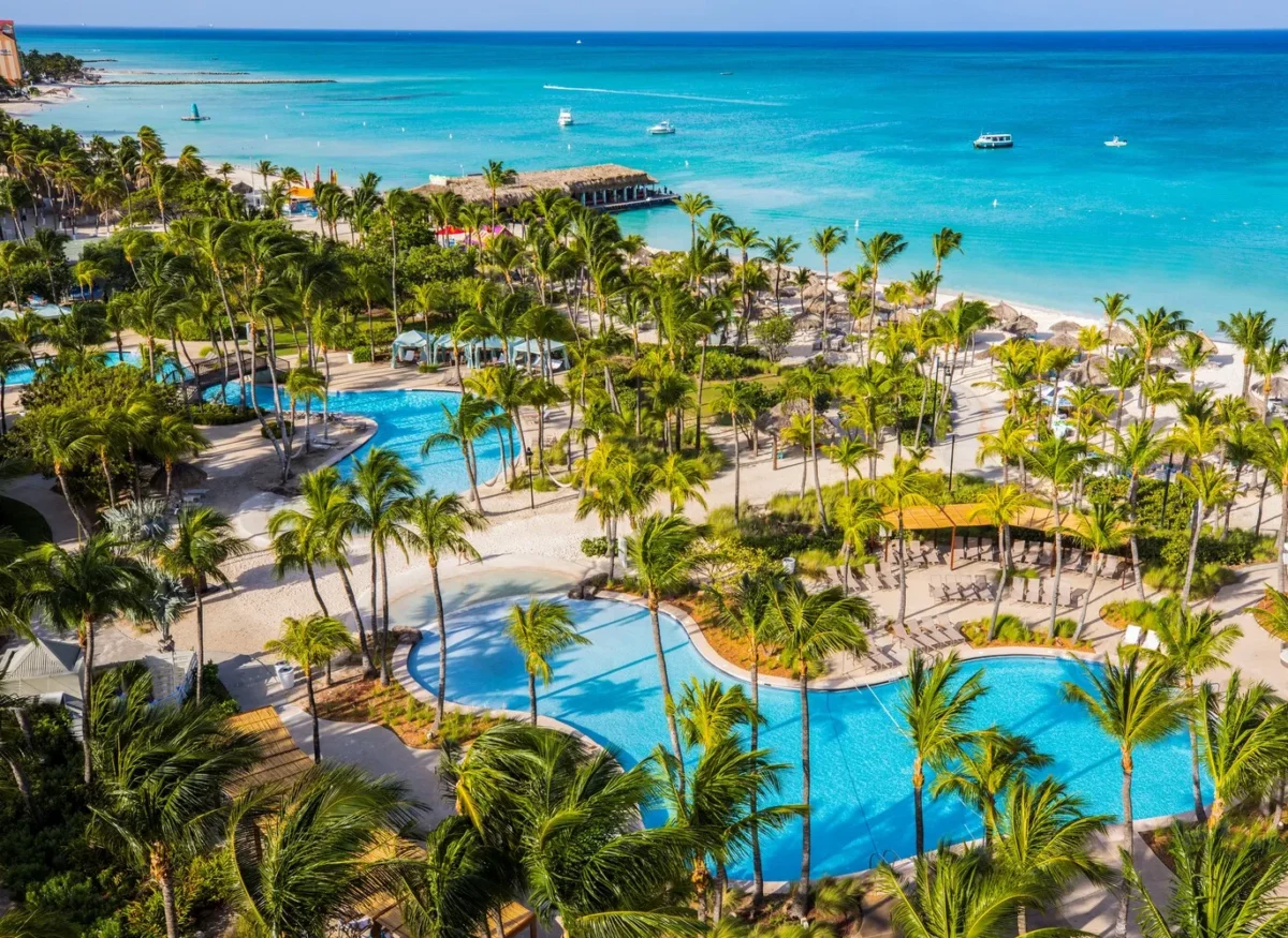 Aerial view of Hilton Aruba Caribbean Resort with pools and beach, perfect for a Hilton Aruba Destination Wedding.
