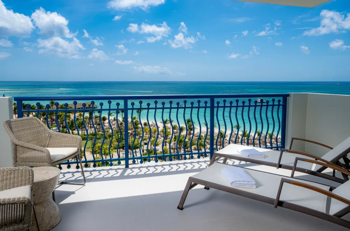 Balcony overlooking the turquoise ocean at Hilton Aruba Caribbean Resort, perfect for a destination wedding.
